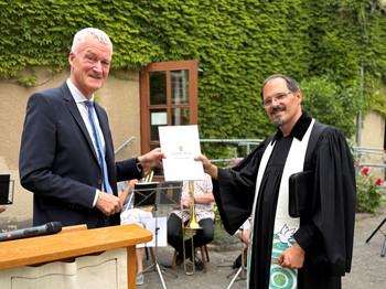 Präsident Pleye und Pfarrer bei Fördermittelbescheidübergabe